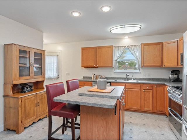 8 Checkerberry Sq Unit 106, Milton, VT 05468 - kitchen with a sink, light flooring, range with two ovens, a center island, and a kitchen breakfast bar