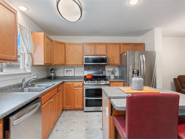 8 Checkerberry Sq Unit 106, Milton, VT 05468 - kitchen with appliances with stainless steel finishes, a sink, light flooring, a kitchen island, and open shelves