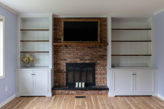 82 Stirrup Cir, Williston, VT 05495 - unfurnished living room featuring light wood-style flooring, crown molding, a fireplace, and baseboards