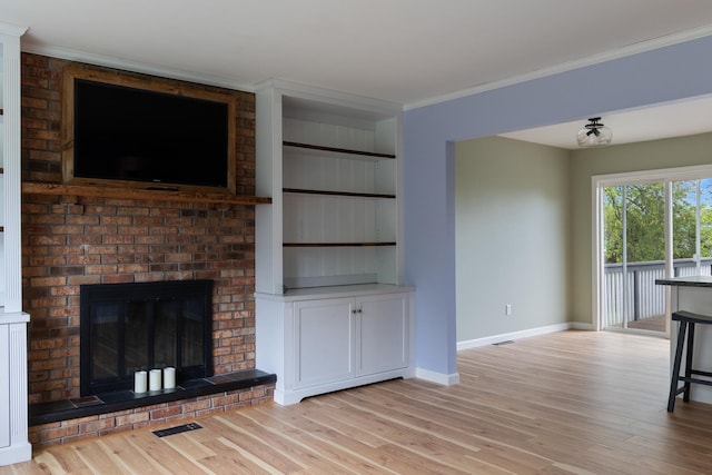 82 Stirrup Cir, Williston, VT 05495 - unfurnished living room with baseboards, light wood-style floors, ornamental molding, a fireplace, and built in features