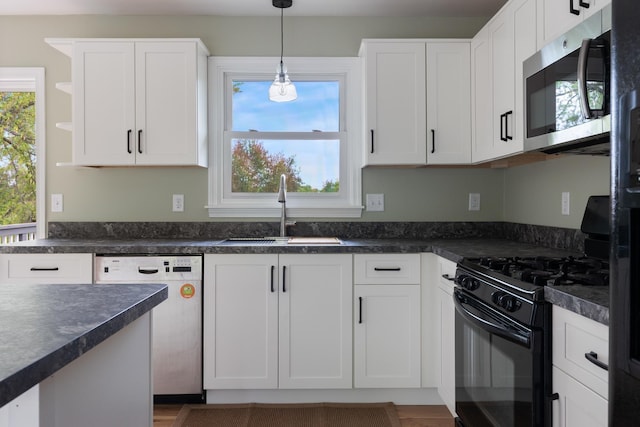 82 Stirrup Cir, Williston, VT 05495 - kitchen featuring dishwashing machine, black gas stove, stainless steel microwave, a sink, and dark countertops