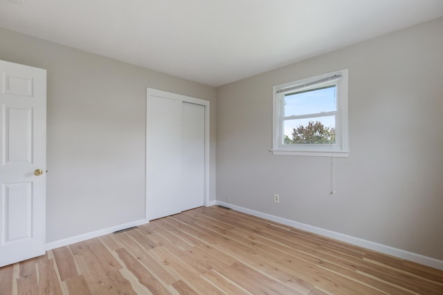 82 Stirrup Cir, Williston, VT 05495 - unfurnished bedroom with light wood-type flooring, baseboards, and a closet