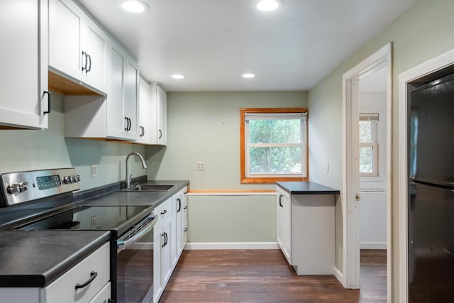 82 Stirrup Cir, Williston, VT 05495 - kitchen with electric stove, freestanding refrigerator, a sink, dark wood-type flooring, and dark countertops