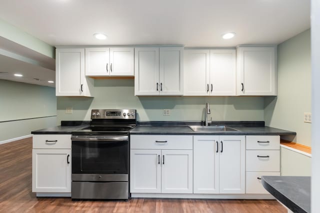 82 Stirrup Cir, Williston, VT 05495 - kitchen featuring stainless steel range with electric cooktop, a sink, wood finished floors, dark countertops, and white cabinets