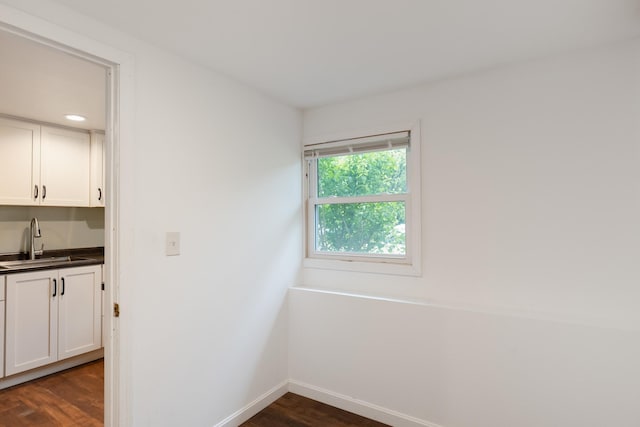 82 Stirrup Cir, Williston, VT 05495 - empty room with dark wood-type flooring, bar with sink, and baseboards
