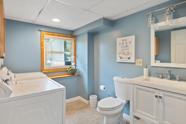 82 Stirrup Cir, Williston, VT 05495 - bathroom with washing machine and dryer, vanity, toilet, a drop ceiling, and baseboards