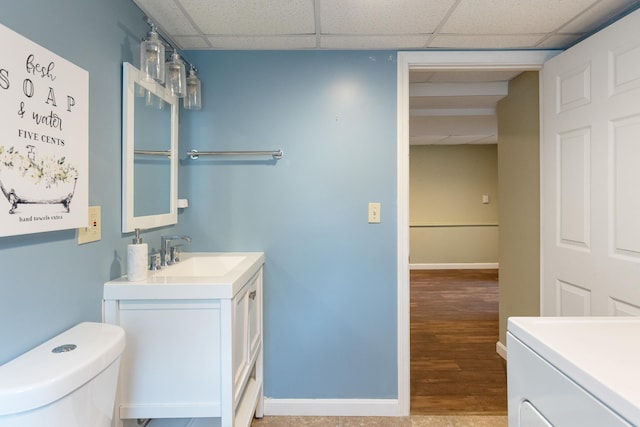 82 Stirrup Cir, Williston, VT 05495 - bathroom with vanity, toilet, a drop ceiling, wood finished floors, and baseboards