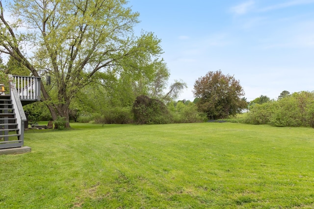 82 Stirrup Cir, Williston, VT 05495 - view of green lawn featuring stairway and a deck