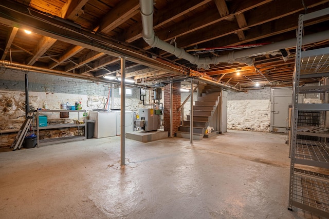 546 Salmon Falls Rd, Rochester, NH 03868 - unfinished below grade area featuring washing machine and clothes dryer, stairs, and a heating unit
