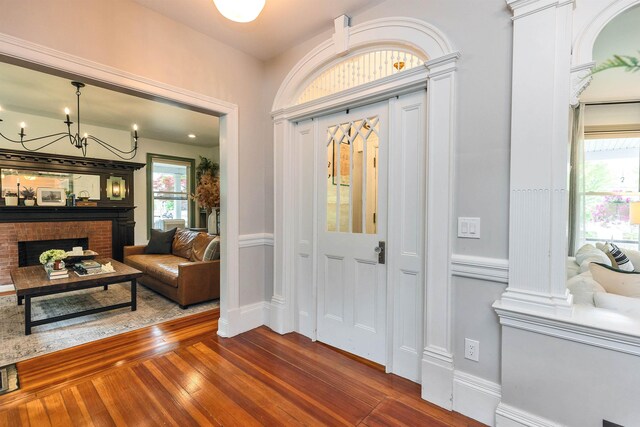 120 S Mast St, Goffstown, NH 03045 - foyer with dark wood finished floors, a chandelier, baseboards, and a fireplace