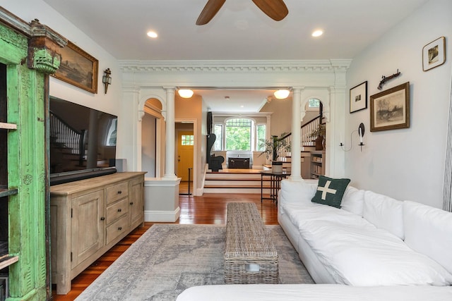 120 S Mast St, Goffstown, NH 03045 - living room featuring ornate columns, stairway, dark wood-style floors, ceiling fan, and crown molding