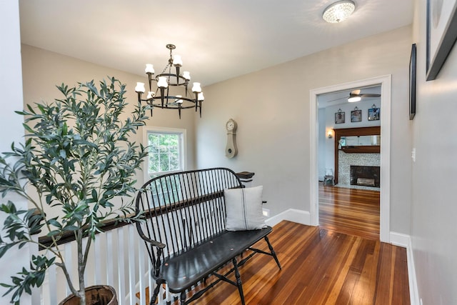 120 S Mast St, Goffstown, NH 03045 - staircase featuring wood-type flooring, a chandelier, ceiling fan, baseboards, and a fireplace with flush hearth