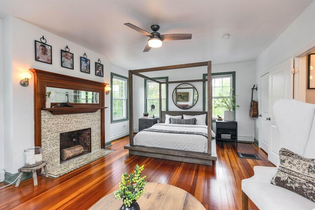 120 S Mast St, Goffstown, NH 03045 - bedroom with multiple windows, wood-type flooring, a tile fireplace, and a ceiling fan