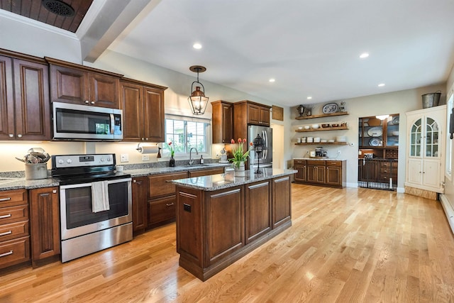 120 S Mast St, Goffstown, NH 03045 - kitchen featuring appliances with stainless steel finishes, a sink, a center island, open shelves, and light wood-type flooring