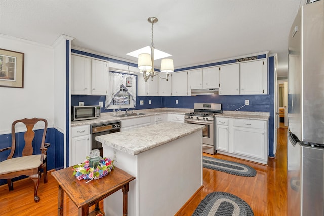 26 Birch Hill Estates Rd, Wolfeboro, NH 03894 - kitchen with appliances with stainless steel finishes, light wood-style floors, light countertops, a sink, and white cabinetry