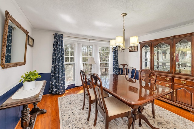 26 Birch Hill Estates Rd, Wolfeboro, NH 03894 - dining room featuring a chandelier, a textured ceiling, crown molding, and wood finished floors