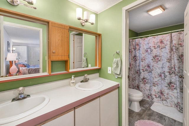 26 Birch Hill Estates Rd, Wolfeboro, NH 03894 - ensuite bathroom featuring wood finished floors, ornamental molding, double vanity, toilet, and a shower with curtain