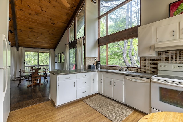 46 Murray Hill Heights Rd Unit 17, Manchester, VT 05255 - kitchen with white appliances, a sink, under cabinet range hood, high vaulted ceiling, and dark countertops