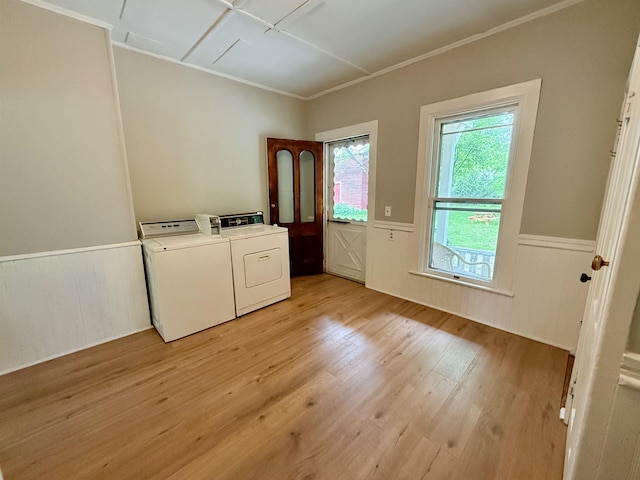 927 Water St, Bennington, VT 05257 - laundry area with separate washer and dryer, crown molding, a wainscoted wall, and light wood-style floors