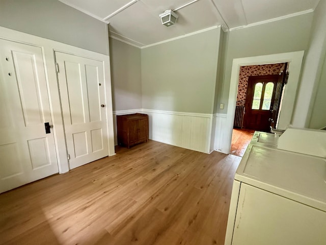 927 Water St, Bennington, VT 05257 - unfurnished dining area with separate washer and dryer, light wood finished floors, a wainscoted wall, and crown molding