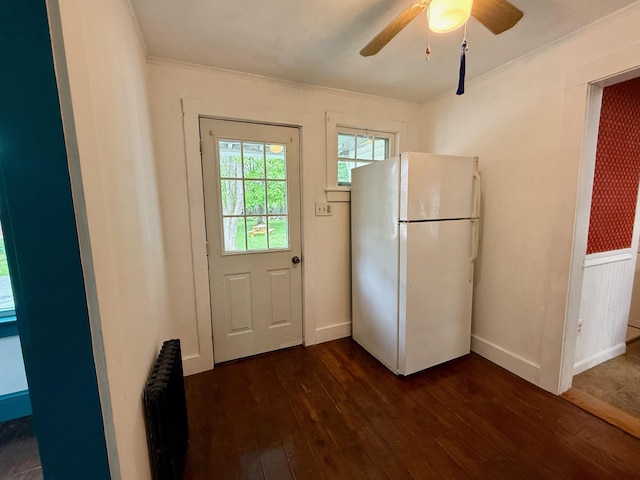 927 Water St, Bennington, VT 05257 - doorway featuring dark wood finished floors, ornamental molding, radiator, ceiling fan, and baseboards