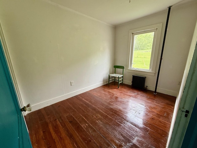 927 Water St, Bennington, VT 05257 - empty room featuring radiator heating unit, dark wood-style flooring, baseboards, and ornamental molding