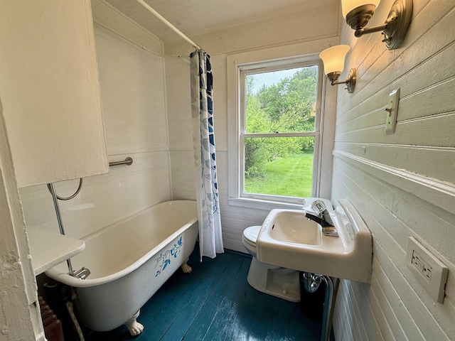 927 Water St, Bennington, VT 05257 - bathroom with plenty of natural light, toilet, wood finished floors, and shower / bath combination with curtain
