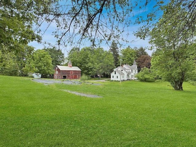 927 Water St, Bennington, VT 05257 - view of green lawn with a barn, an outbuilding, and view of wooded area