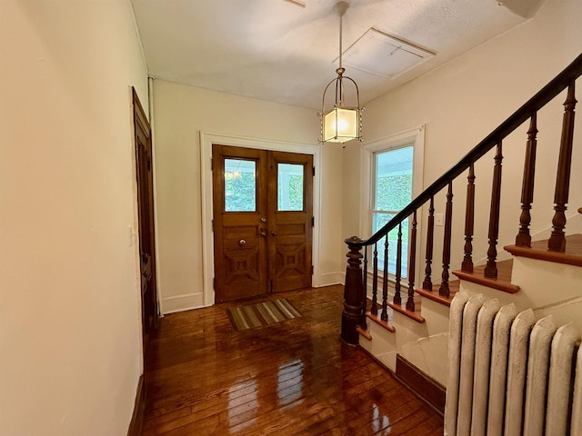 927 Water St, Bennington, VT 05257 - entryway with radiator, hardwood / wood-style floors, baseboards, and stairway