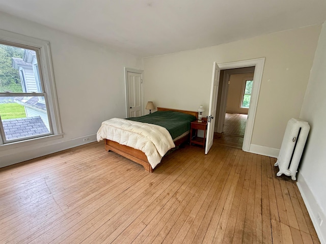 927 Water St, Bennington, VT 05257 - bedroom with radiator heating unit, light wood-type flooring, and baseboards