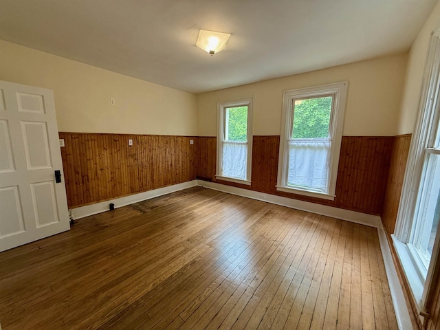927 Water St, Bennington, VT 05257 - empty room with wainscoting, wood-type flooring, and wooden walls