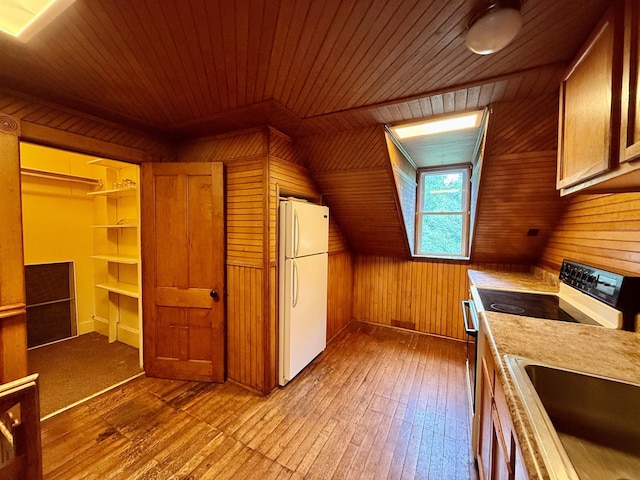 927 Water St, Bennington, VT 05257 - kitchen with freestanding refrigerator, wood walls, wood-type flooring, range with electric stovetop, and wood ceiling