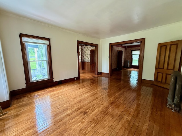 927 Water St, Bennington, VT 05257 - empty room featuring healthy amount of natural light, hardwood / wood-style flooring, baseboards, and ornamental molding