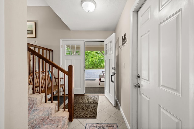 55 Honey Hill Rd, Hinesburg, VT 05461 - entrance foyer featuring light tile patterned floors, stairway, and baseboards
