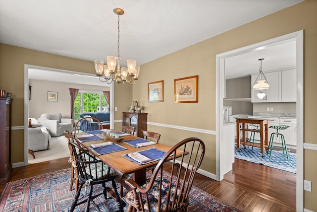 55 Honey Hill Rd, Hinesburg, VT 05461 - dining room featuring dark wood finished floors, a chandelier, and baseboards