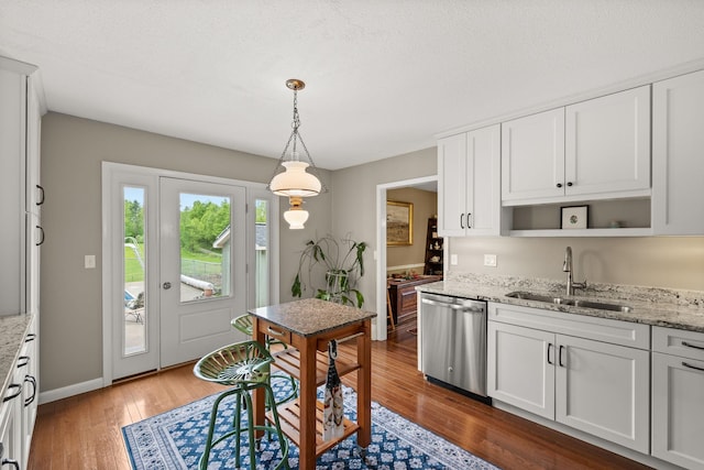 55 Honey Hill Rd, Hinesburg, VT 05461 - kitchen featuring stainless steel dishwasher, a sink, wood finished floors, open shelves, and light stone counters