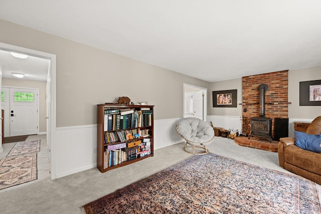 55 Honey Hill Rd, Hinesburg, VT 05461 - carpeted living area with a wood stove and a wainscoted wall