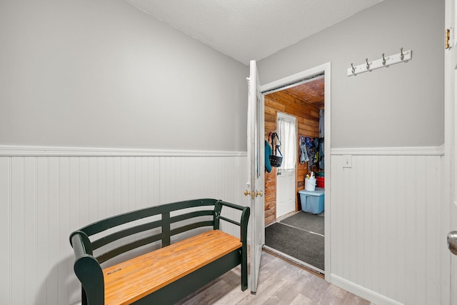 55 Honey Hill Rd, Hinesburg, VT 05461 - bedroom featuring wainscoting, light wood-style flooring, and a textured ceiling