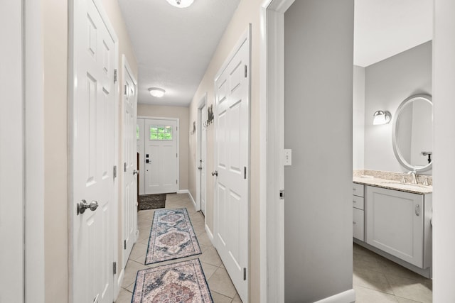 55 Honey Hill Rd, Hinesburg, VT 05461 - corridor with light tile patterned flooring, a sink, and baseboards