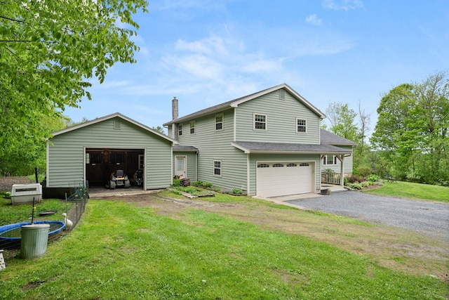 55 Honey Hill Rd, Hinesburg, VT 05461 - rear view of house with a yard, a detached garage, and an outdoor structure