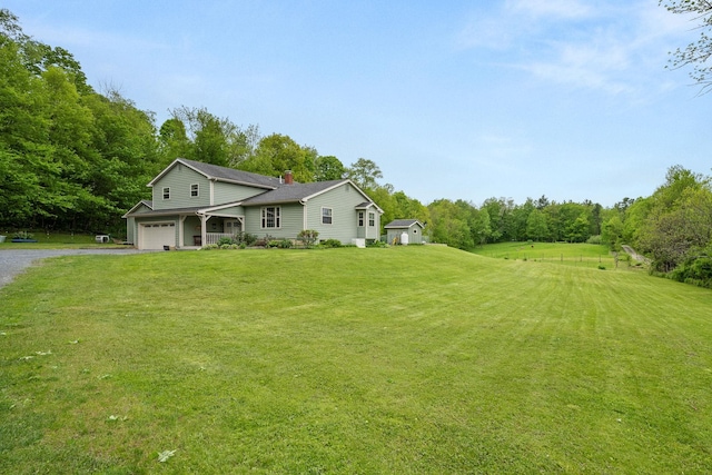 55 Honey Hill Rd, Hinesburg, VT 05461 - view of front of house featuring gravel driveway, an attached garage, a front lawn, and a chimney