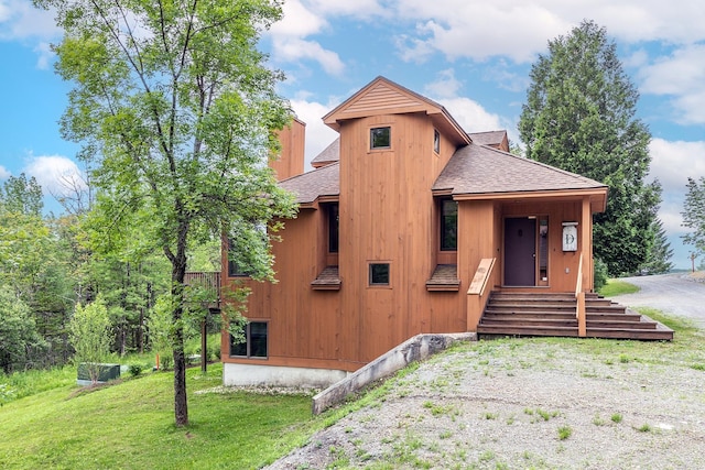 46 Willows Way Unit 5, Peru, VT 05152 - view of front of house featuring a shingled roof, a front yard, and a chimney