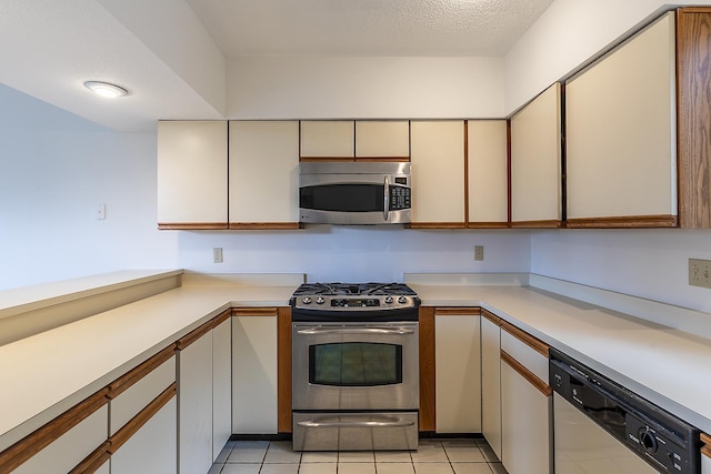 46 Willows Way Unit 5, Peru, VT 05152 - kitchen featuring stainless steel appliances, light countertops, and light tile patterned floors