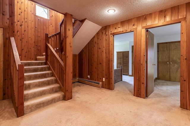 46 Willows Way Unit 5, Peru, VT 05152 - stairs with a baseboard heating unit, carpet, wood walls, and a textured ceiling