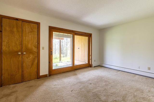 46 Willows Way Unit 5, Peru, VT 05152 - unfurnished bedroom featuring access to outside, carpet, a baseboard heating unit, baseboards, and a textured ceiling
