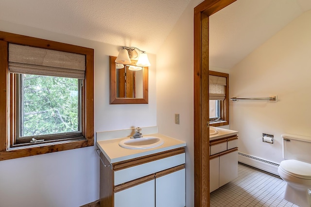 46 Willows Way Unit 5, Peru, VT 05152 - bathroom featuring a baseboard heating unit, vanity, toilet, vaulted ceiling, and tile patterned floors