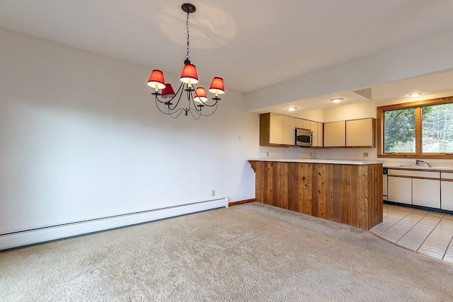 46 Willows Way Unit 5, Peru, VT 05152 - kitchen featuring stainless steel microwave, light carpet, a baseboard heating unit, light countertops, and decorative light fixtures