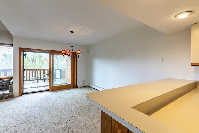 46 Willows Way Unit 5, Peru, VT 05152 - kitchen with light colored carpet, a chandelier, decorative light fixtures, a baseboard radiator, and a peninsula