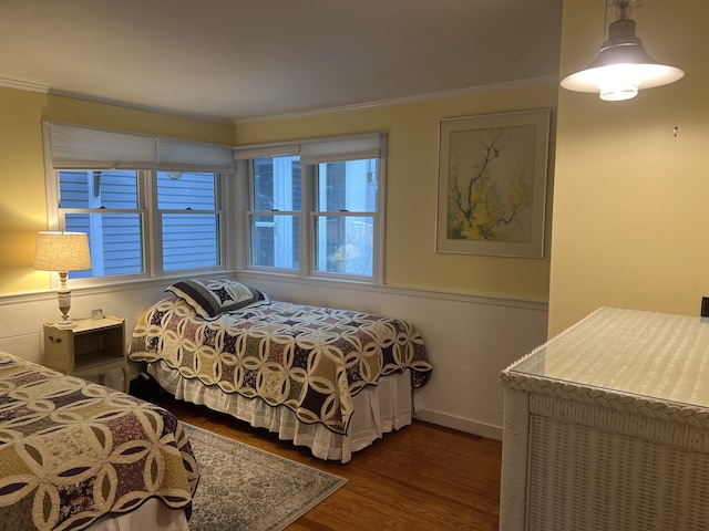 87 Chase Point Rd, Tuftonboro, NH 03853 - bedroom featuring dark wood finished floors, crown molding, and a wainscoted wall