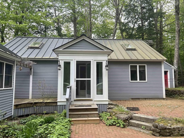 87 Chase Point Rd, Tuftonboro, NH 03853 - view of front of house featuring a standing seam roof, metal roof, and a deck